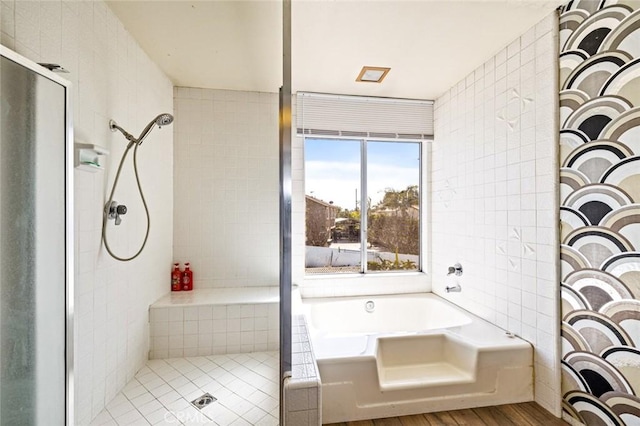 full bath with a stall shower, a garden tub, tile walls, and wood finished floors