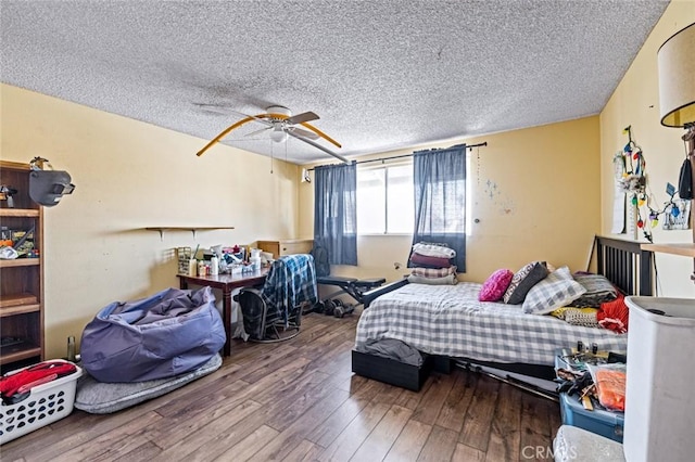 bedroom with ceiling fan, a textured ceiling, and hardwood / wood-style floors