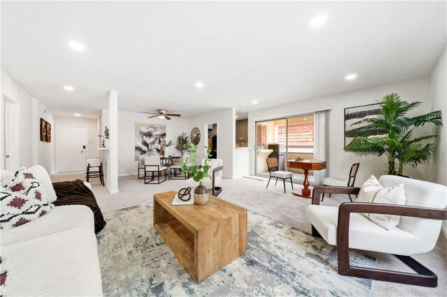 living room featuring recessed lighting, carpet, baseboards, and a ceiling fan