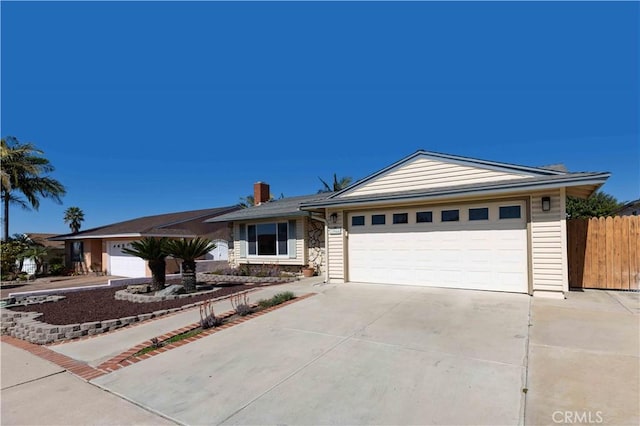 single story home featuring a garage, concrete driveway, a chimney, and fence