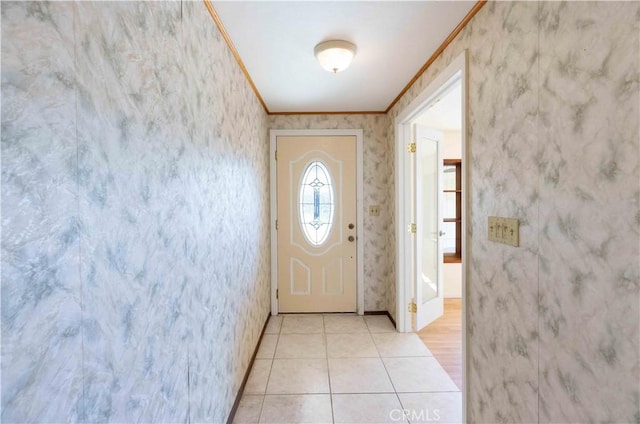 entryway with light tile patterned floors, crown molding, baseboards, and wallpapered walls