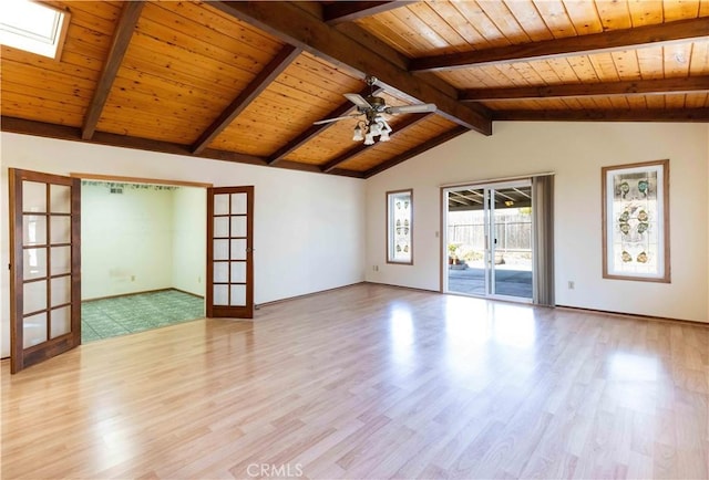 unfurnished living room with vaulted ceiling with skylight, wooden ceiling, ceiling fan, wood finished floors, and french doors