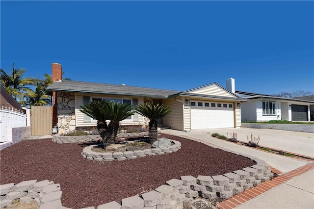 ranch-style home with driveway, a garage, stone siding, a chimney, and a gate