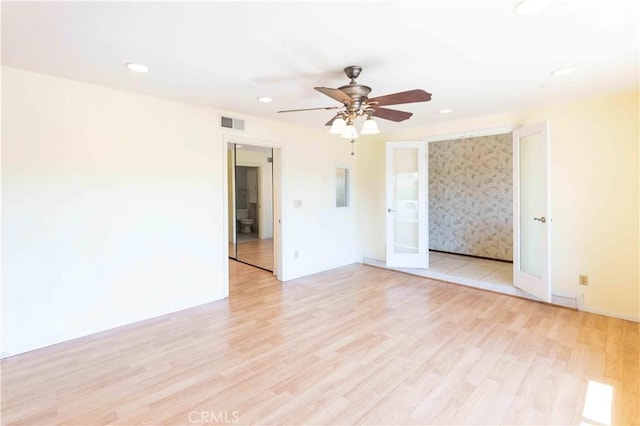 unfurnished room with ceiling fan, light wood-type flooring, visible vents, and recessed lighting