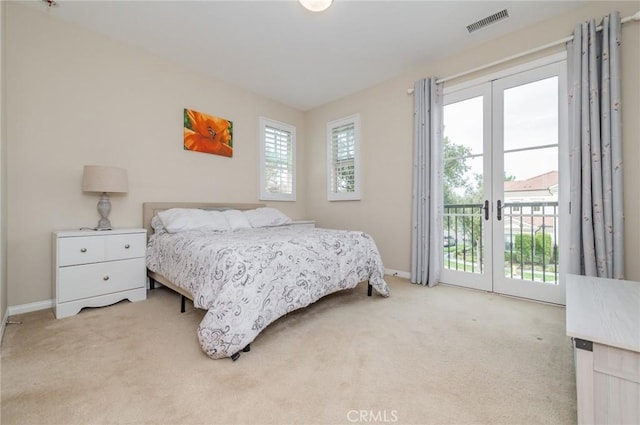 bedroom featuring light colored carpet, visible vents, baseboards, access to outside, and french doors