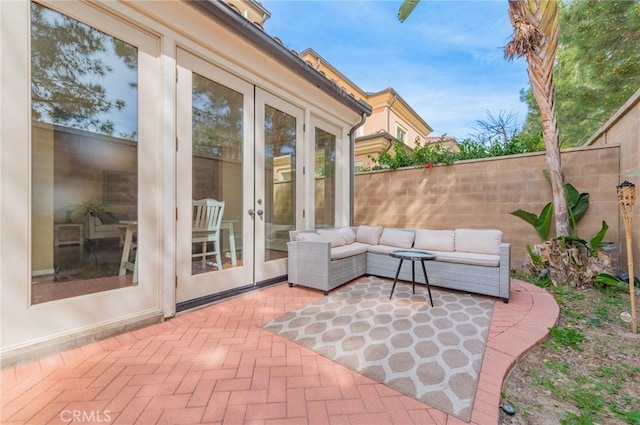 view of patio with fence private yard, an outdoor living space, and french doors