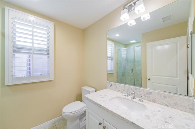 full bathroom featuring toilet, vanity, visible vents, a shower stall, and tile patterned floors