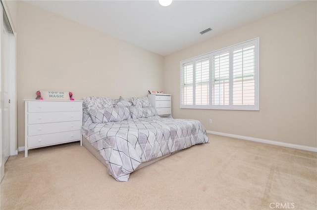 carpeted bedroom with visible vents and baseboards