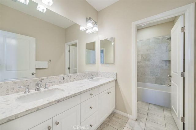 bathroom with double vanity, bathtub / shower combination, baseboards, and a sink