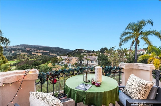 balcony featuring outdoor dining space and a mountain view