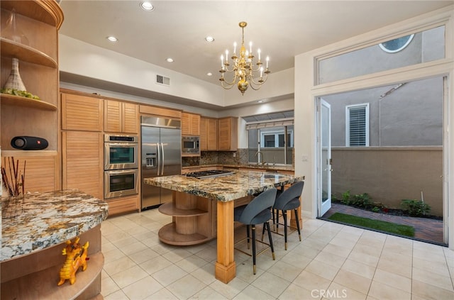 kitchen featuring tasteful backsplash, a kitchen breakfast bar, built in appliances, stone counters, and open shelves