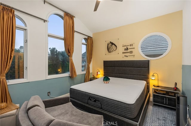 bedroom with lofted ceiling, carpet flooring, and a ceiling fan