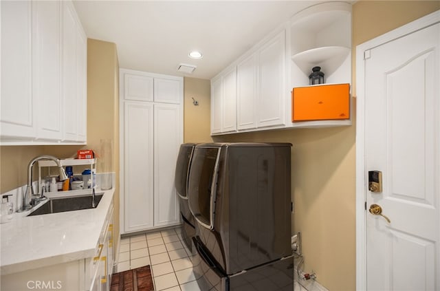 laundry area featuring cabinet space, light tile patterned flooring, separate washer and dryer, a sink, and recessed lighting