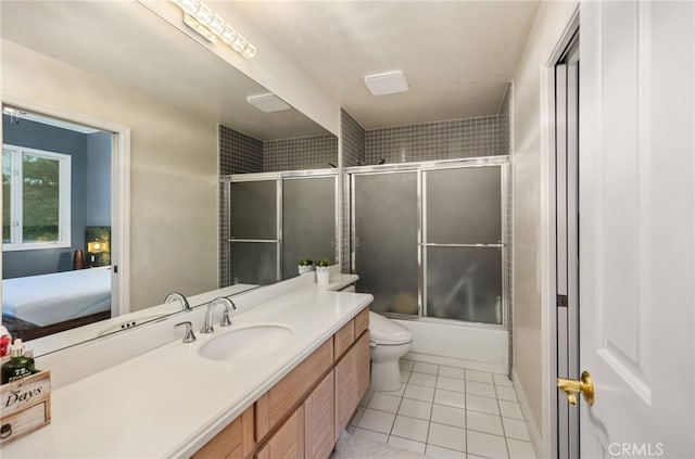 bathroom featuring shower / bath combination with glass door, toilet, ensuite bathroom, vanity, and tile patterned floors