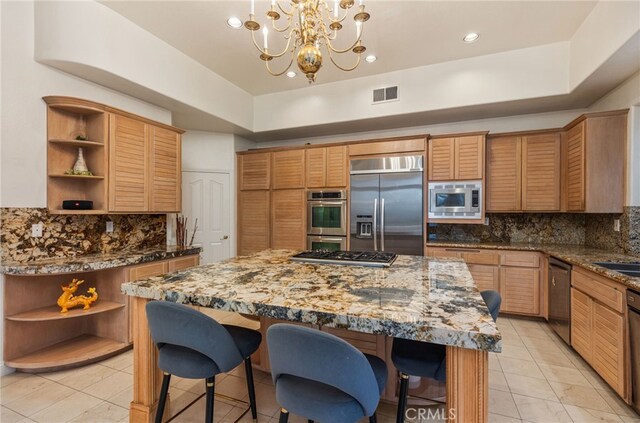 kitchen with visible vents, open shelves, a breakfast bar area, and built in appliances