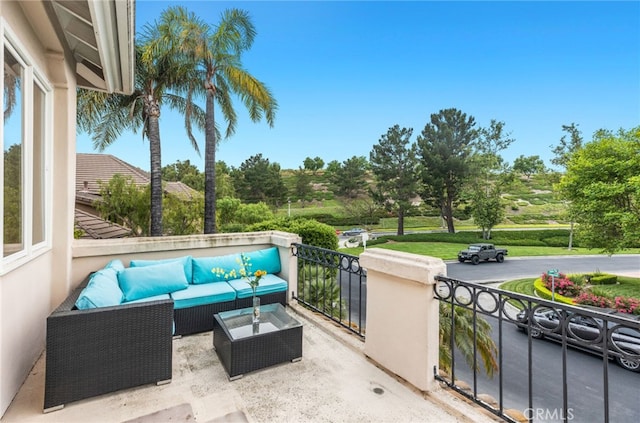 view of patio / terrace featuring a balcony and an outdoor living space