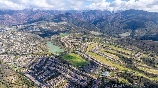 aerial view featuring a water and mountain view