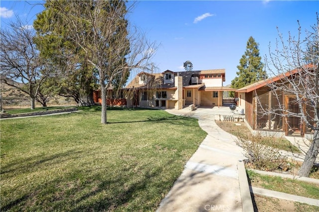 view of home's community featuring a patio area and a yard