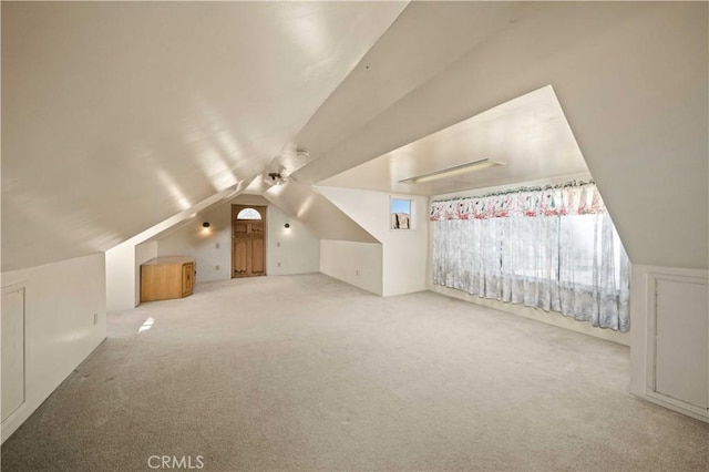 bonus room featuring carpet flooring and vaulted ceiling