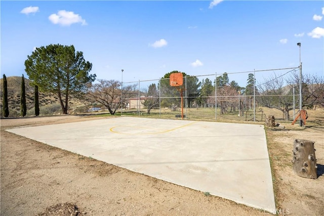 view of basketball court featuring community basketball court and fence