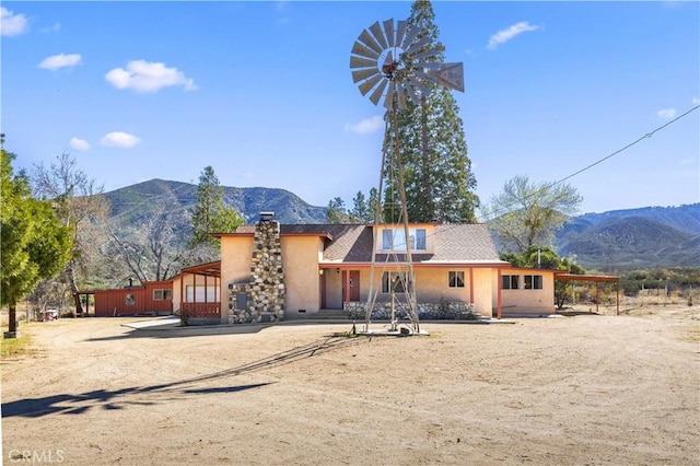 31251 Aliso Canyon Rd, Acton, CA 93550 - view of front facade with a chimney, stucco siding, and a mountain view