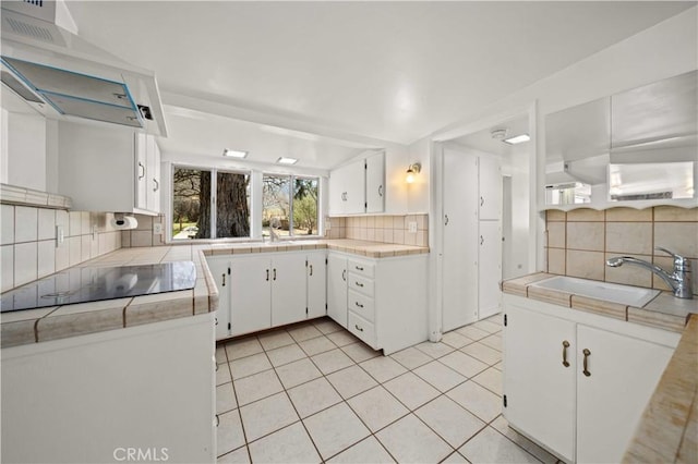 31251 Aliso Canyon Rd, Acton, CA 93550 - kitchen featuring wall chimney range hood, tile countertops, decorative backsplash, and a sink
