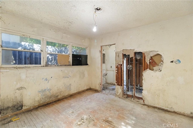 unfurnished room featuring a textured ceiling