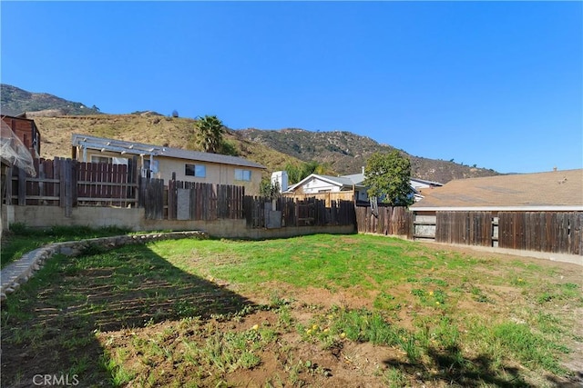 view of yard with a mountain view and fence