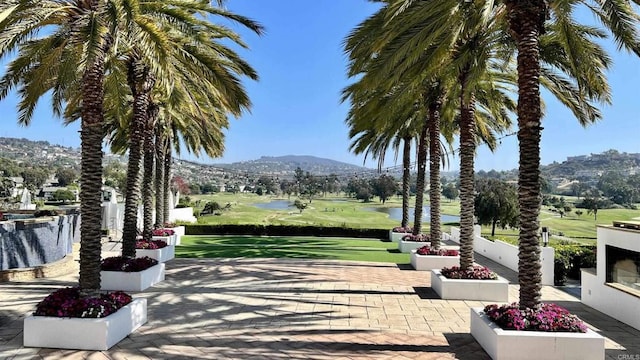 view of property's community featuring a yard and a mountain view