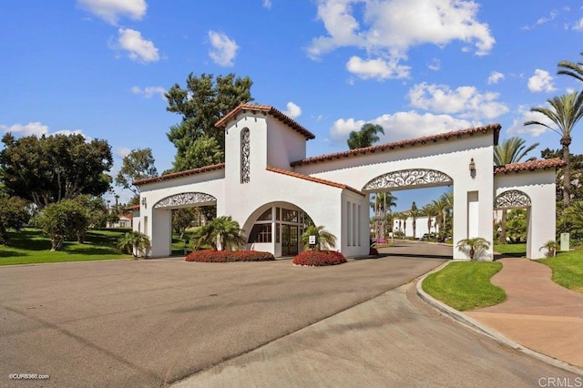 mediterranean / spanish-style home with curved driveway