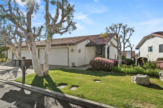 view of front facade with stucco siding, an attached garage, a front yard, driveway, and a tiled roof