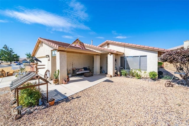 back of property featuring a patio area, a tiled roof, and stucco siding