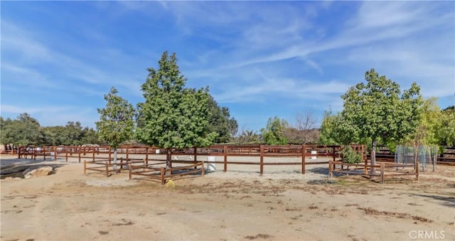 view of yard featuring an enclosed area and a rural view