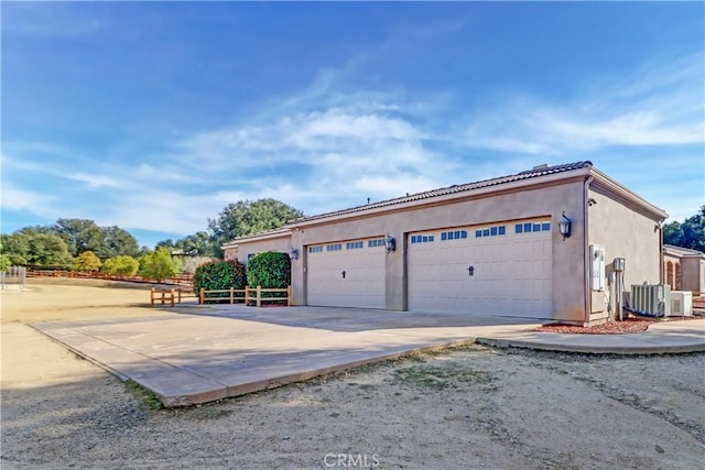 garage with central AC and driveway