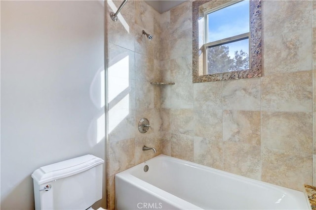 bathroom with tub / shower combination and toilet