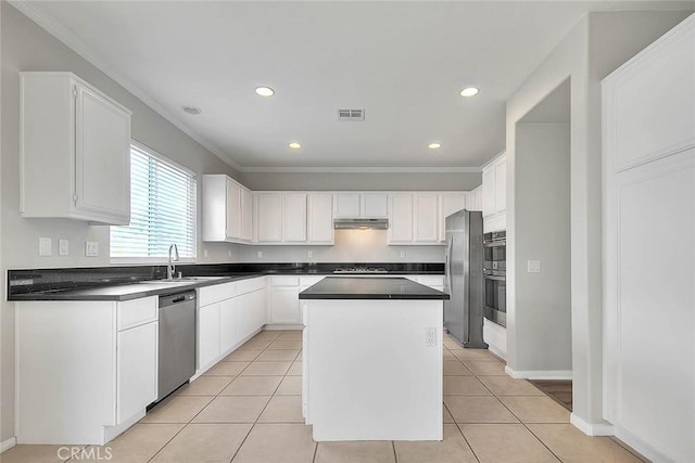 kitchen with light tile patterned floors, visible vents, a center island, stainless steel appliances, and under cabinet range hood