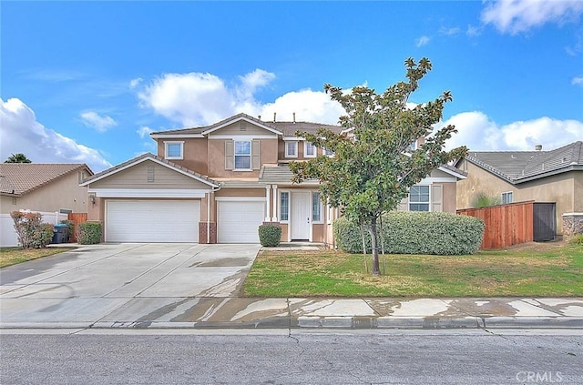 traditional-style home featuring fence, a front lawn, and concrete driveway