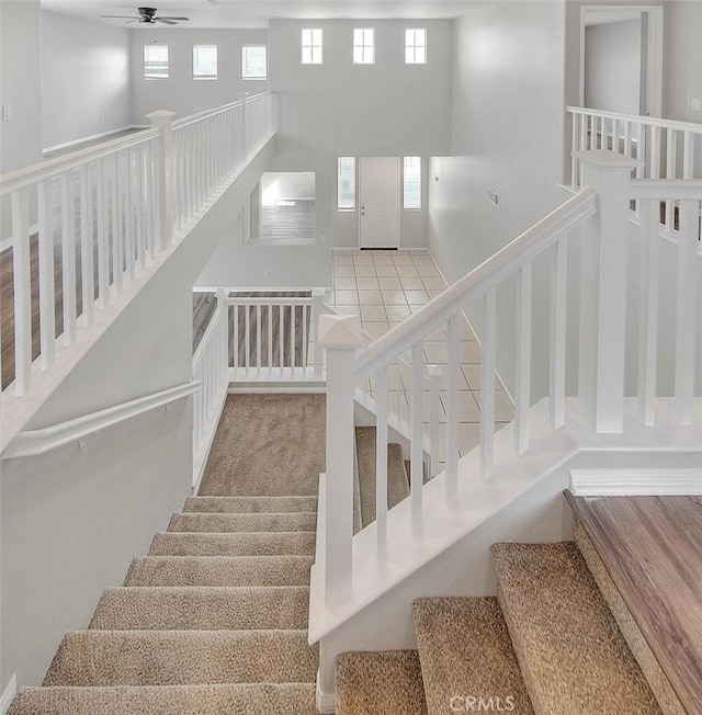 stairs with a ceiling fan