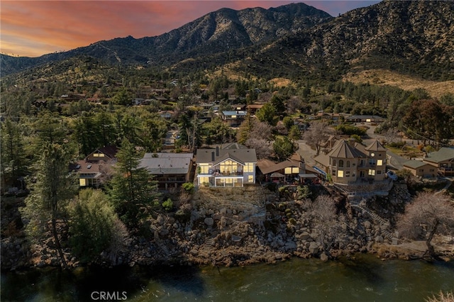 aerial view at dusk featuring a mountain view