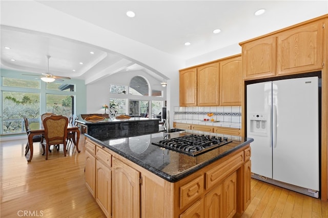 848 Burlando Rd, Kernville, CA 93238 - kitchen with light wood finished floors, dark stone counters, recessed lighting, stainless steel gas stovetop, and white refrigerator with ice dispenser