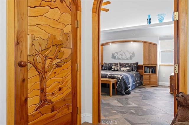 848 Burlando Rd, Kernville, CA 93238 - bedroom featuring arched walkways, baseboards, and stone finish floor