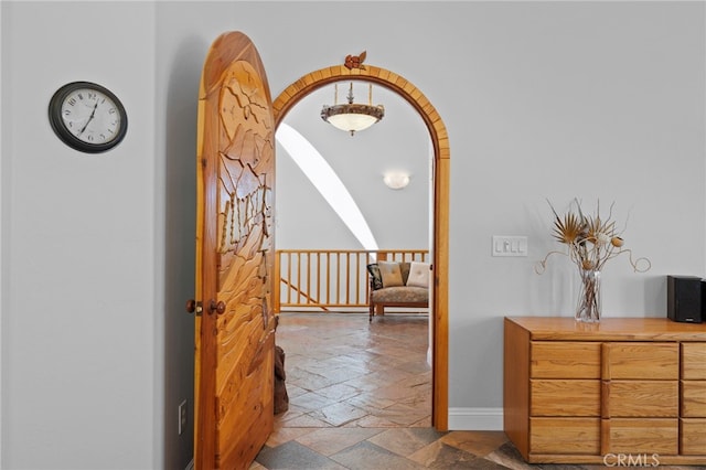 848 Burlando Rd, Kernville, CA 93238 - hallway featuring baseboards, stone tile flooring, and an upstairs landing