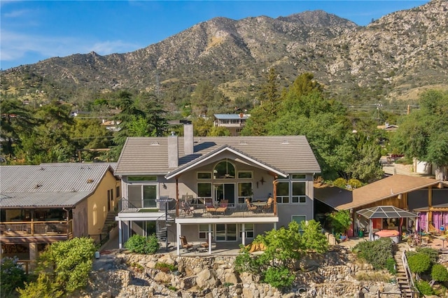 848 Burlando Rd, Kernville, CA 93238 - rear view of house featuring stucco siding, a chimney, stairway, and a mountain view