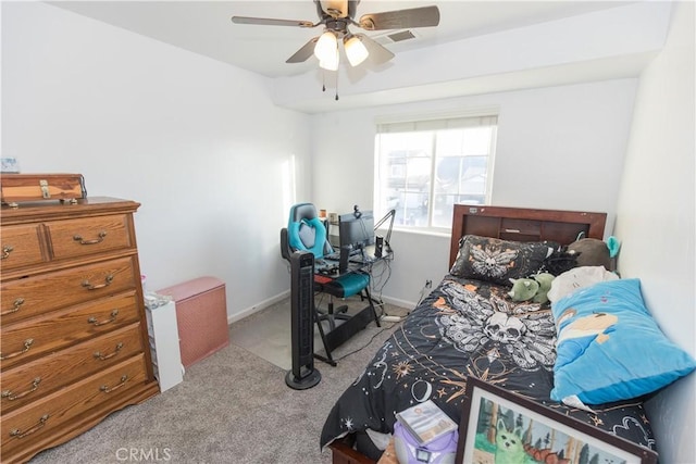 carpeted bedroom with visible vents, a ceiling fan, and baseboards