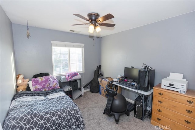 carpeted bedroom featuring a ceiling fan and visible vents