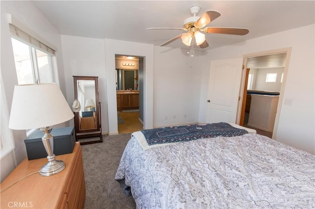 bedroom with carpet floors, connected bathroom, a sink, and a ceiling fan