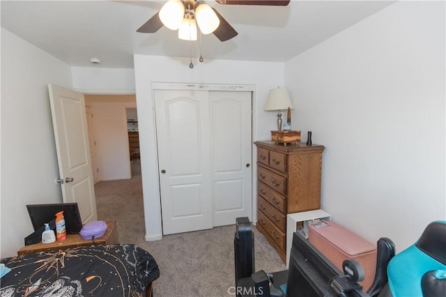 carpeted bedroom featuring a ceiling fan and a closet