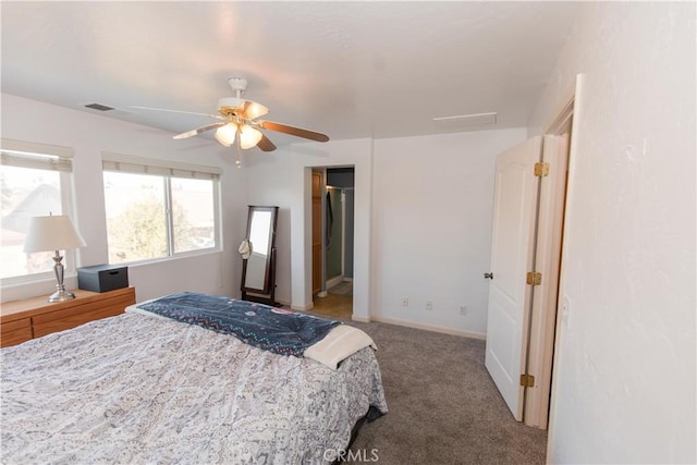 carpeted bedroom with baseboards, visible vents, and a ceiling fan