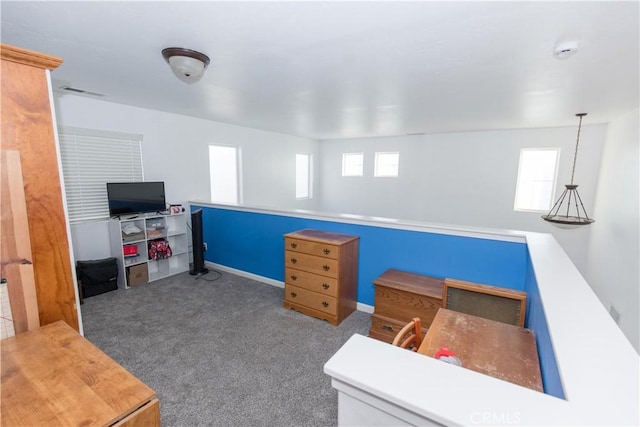 office area featuring carpet floors, visible vents, plenty of natural light, and baseboards