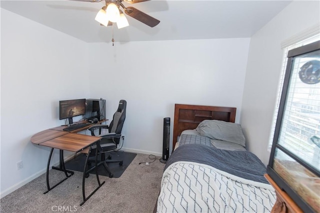 carpeted bedroom with ceiling fan and baseboards